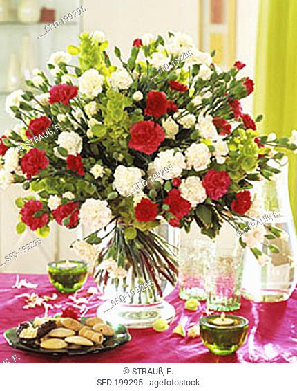 Arrangement of white and red carnations and Bells of Ireland