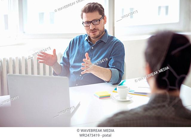 Businessman explaining coworker