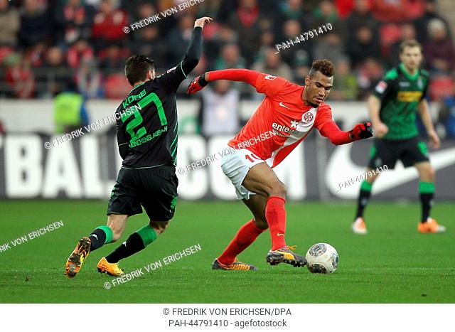 Mainz' Maxim Choupo-Moting (R) and Moenchengladbach's Julian Korb (L) vie for the ball during the Bundesliga soccer match between 1