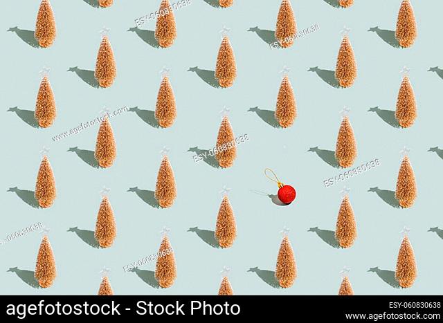 Gray green background pattern with Christmas or New Year symbol attribute objects and symbolic items concept. Golden little toy fir tree with shadow