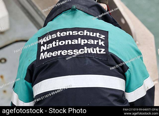 18 October 2021, Schleswig-Holstein, Kiel: ""Coastal Protection National Park Marine Protection"" can be read on a jacket worn by a crew member of the MS...