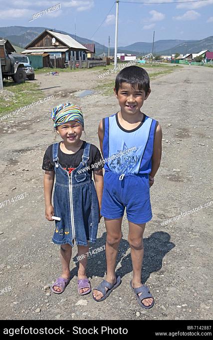 Buryat children, 8 and 5 years old, on the main street of Bolshoye Goloustnoye, Irkutsk Province, Siberia, Russia, Europe