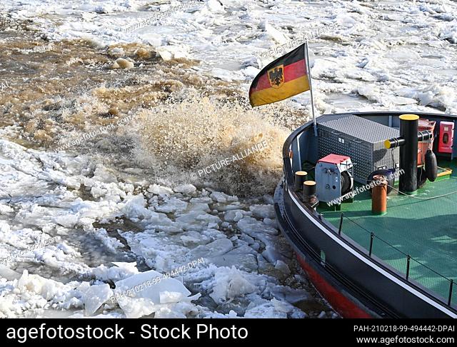 18 February 2021, Brandenburg, Schwedt: A German icebreaker sails on the German-Polish border river Oder. Drift ice is increasing the risk of flooding in some...