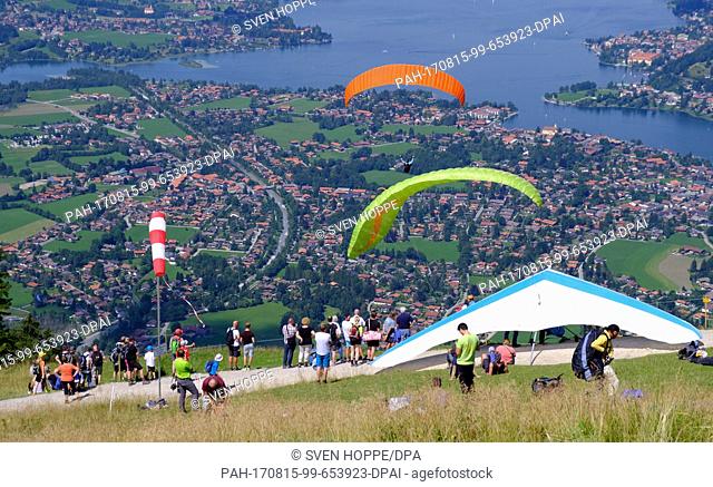 Paragliders take off for a flight across the Tegernsee Lake from the Wallberg at sunny weather in Rottach-Egern, Germany, 15 August 2017
