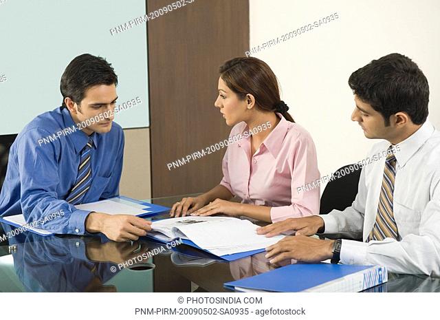 Business executives discussing in a board room
