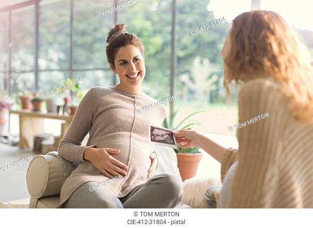 Pregnant women sharing ultrasound