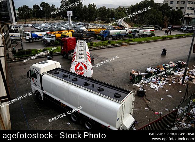 13 January 2022, Lebanon, Beirut: Trucks block a main highway that leads into Beirut as public transport drivers closed major roads across Lebanon to protest a...