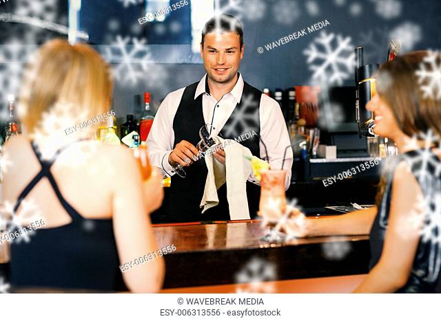 Handsome bartender working while gorgeous friends speaking