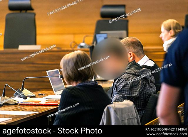 06 October 2023, Baden-Württemberg, Freiburg: The defendant (2nd from left) sits between an interpreter and his defense attorney
