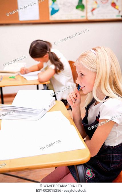 Portrait of pupils doing classwork in a classroom
