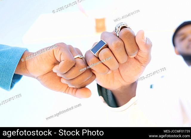 Male and female friend giving fist bump