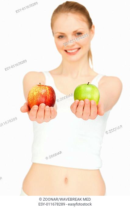 Cheerful woman presenting two apples