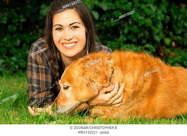 Brunette Woman Praising Golden Retriever Dog Canine Backyard Grass
