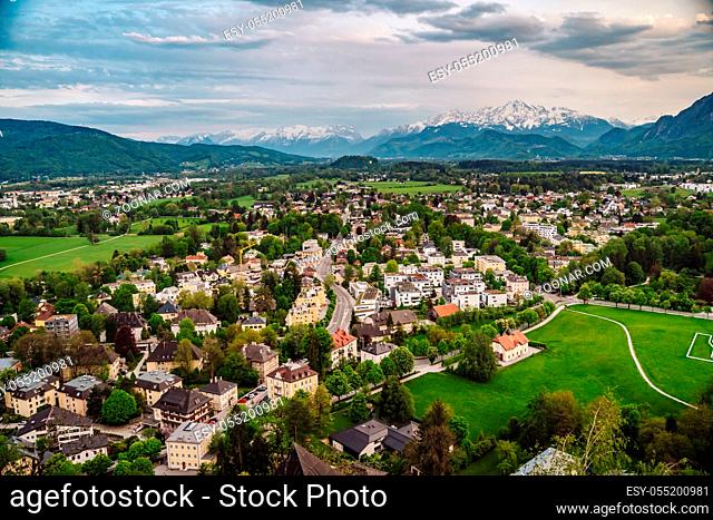 Aerial perspective view on touristic city in the valley surrounded by meadows, forest and rapeseed fields