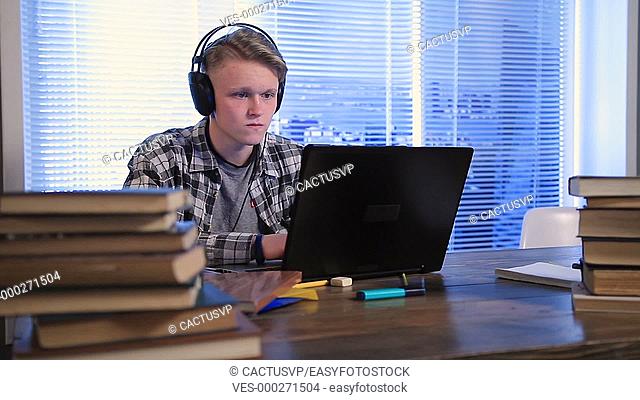Serious student e-learning online with laptop