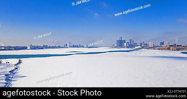 Detroit, Michigan - Downtown Detroit (right) and Windsor, Ontario on the banks of the partially-frozen Detroit River