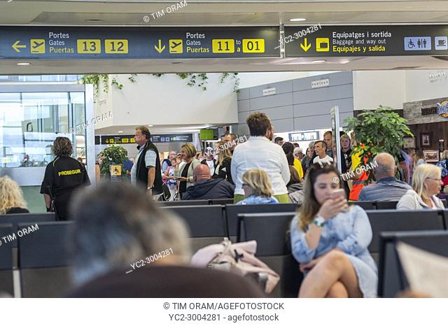 People in a departure lounge at the airport in Mahon , Menorca , Balearic Islands , Spain