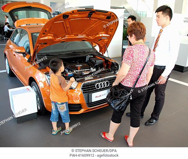 Yang Guohua examines an Audi at a used car dealership in Beijing, China, 24 July 2013. Up until now, most people in China purchase new cars