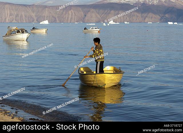A man in a boat in the small village Qaanaaq in northern Greenland, not to far from Thule Air base