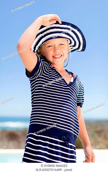 Girl wearing sunhat outdoors