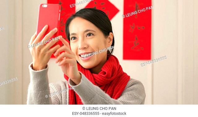 Chinese woman taking selfie in lunar new year holiday