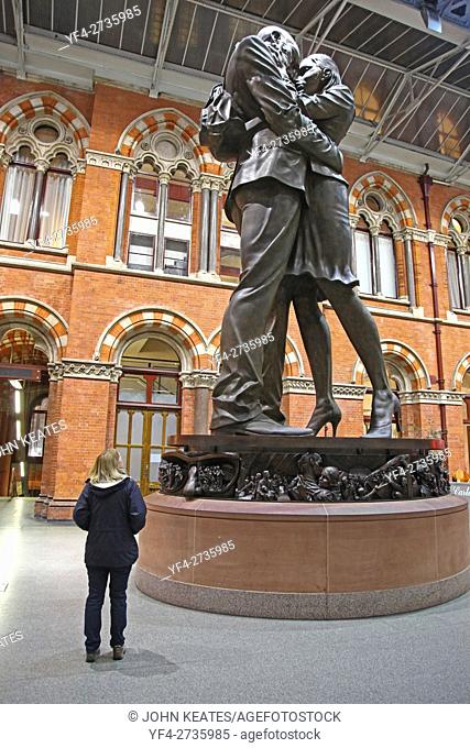 The Meeting place at St Pancras International railway station London England UK a 9m tall bronze statue or sculpture of an intimate pose by sculptor Paul Day