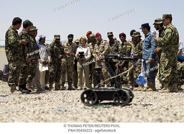 German Defence Minister Ursula von der Leyen (C, CDU) drives a radio controlled bomb disposal robot at a sapper training facility at Camp Shaheen outside...