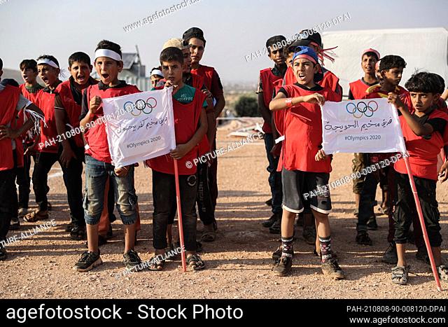 07 August 2021, Syria, Idlib City: Syrian children take part in a parade resembling the Olympics' parade of nations as part of a small-scale Olympic-style event...