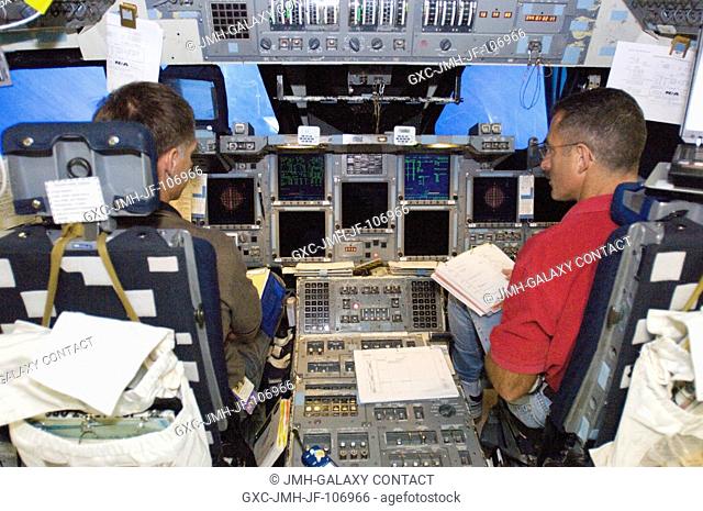 Astronauts Christopher J. Ferguson (left), STS-115 pilot, and Daniel C. Burbank, mission specialist, participate in a training session in the shuttle mission...