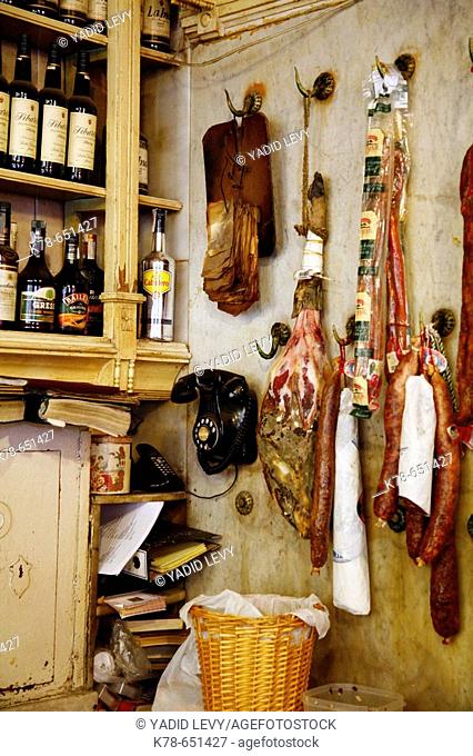 Ham and other pices of dried meat hangs on a kitchen wall at El Rinconcillo, Sevilles oldest tapas bar, Spain