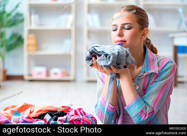 Young housewife doing laundry at home
