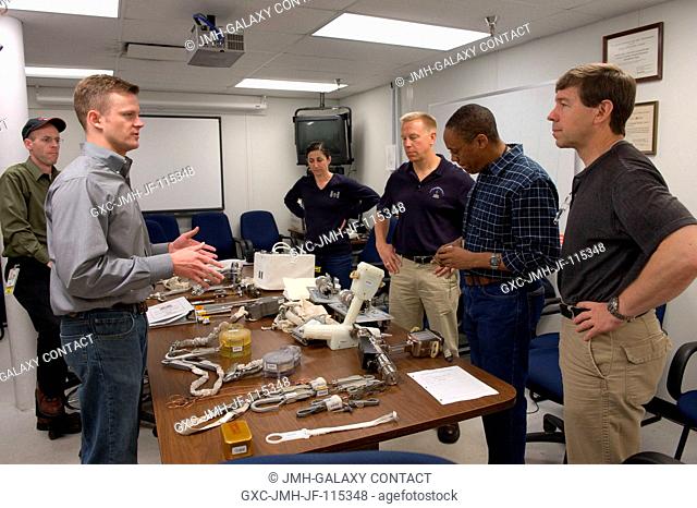 STS-133 crew members participate in an ISS small tools training session in the Neutral Buoyancy Laboratory (NBL) near NASA's Johnson Space Center with...