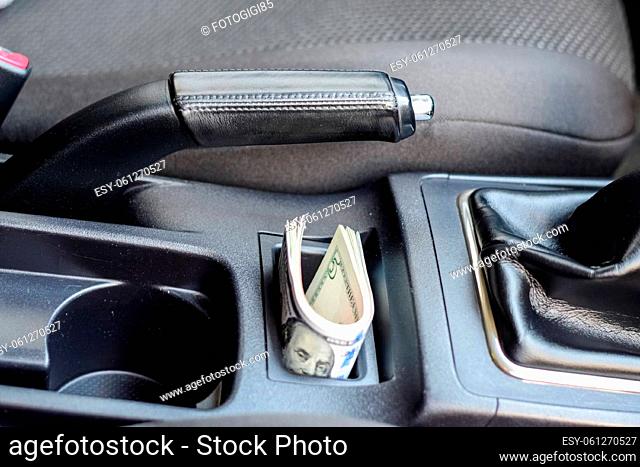 A wad of dollars inside the car. A wad of dollars inside the car