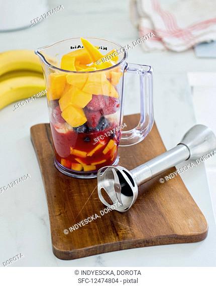 Ingredients for a fruit smoothie in a measuring cup