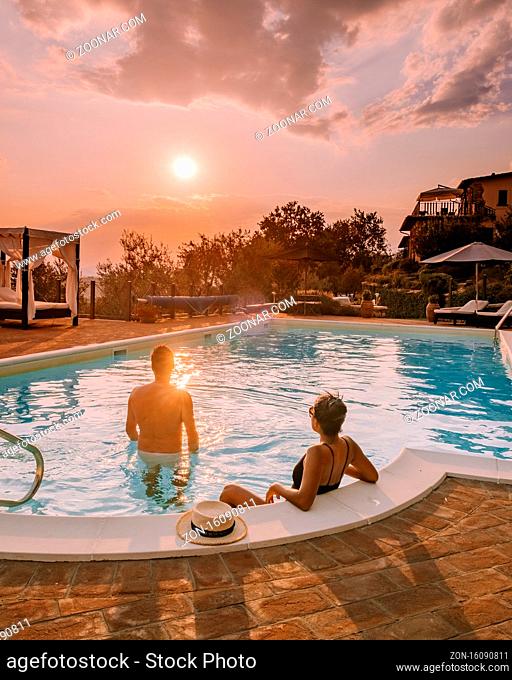 Luxury country house with swimming pool in Italy. Pool and old farm house during sunset central Italy. Couple on Vacation at luxury villa in Italy