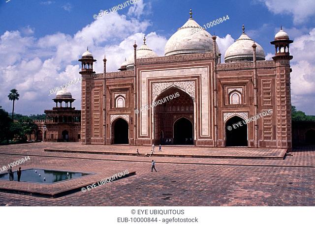 Red sandstone gateway in interior forecourt of Taj Mahal decorated with semi-precious stone inlay, carvings, and geometric pattern