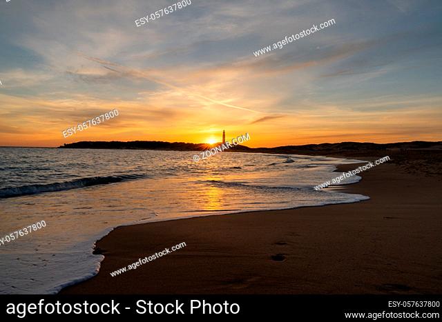 Peaceful sunset on the Playa de Maria Sucia Beach with the Cape Trafalgar Lighthouse in the background