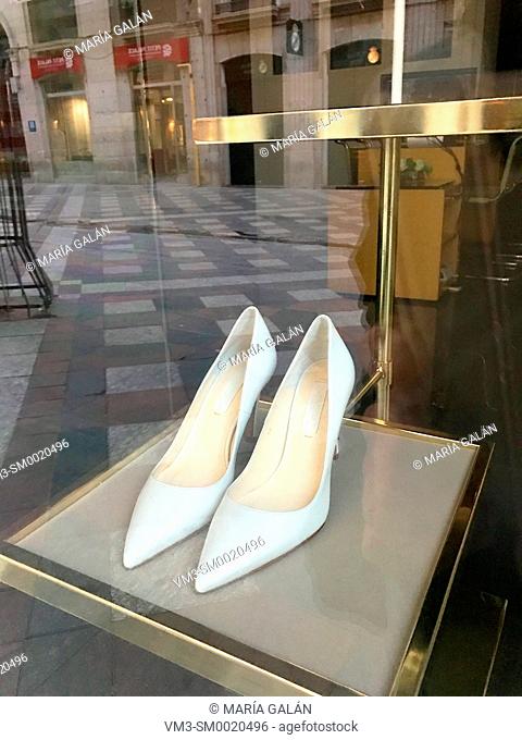 Pair of white high heel shoes in a shop window. Madrid, Spain