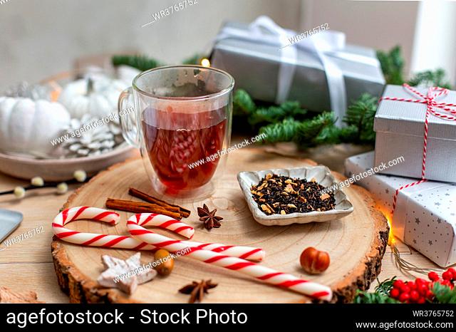 Christmas, a glass of mulled cider or wine with spices, candy canes and decorations