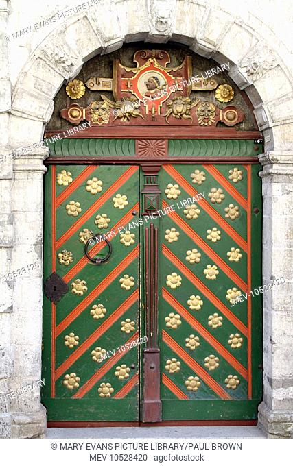 Green, gold and red decorated door on the House of the Brotherhood of the Blackheads in Tallinn, Estonia