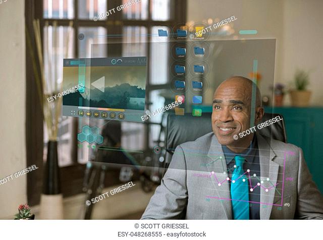Smiling professional using a futuristic computer desktop screen