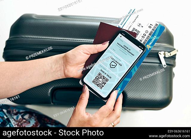 Digital covid certificate. Covid negative rapid digital test pass. Woman passenger holding digital medical pass on her mobile phone