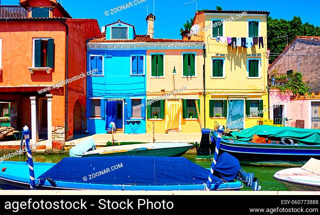 Cozy colorful houses and canal with boats in Burano Island in Venice, Italy. Cityscape, venetian view