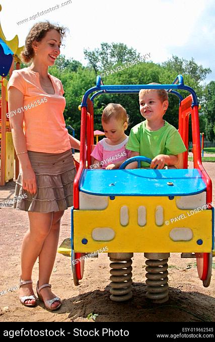 mother and children on car toy