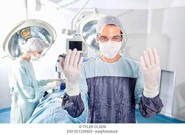 Male surgeon asking for gloves