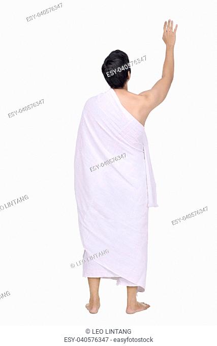 Rear view of asian muslim with ihram cloth standing isolated over white background