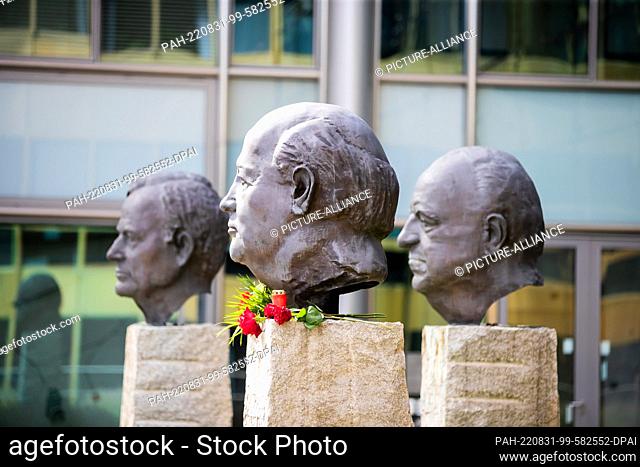 31 August 2022, Berlin: Flowers lie at the monument ""Fathers of Unity"" by French sculptor Serge Mangin at the head of the last president of the Soviet Union...