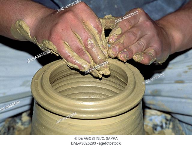 Machining a jar at a pottery workshop, Castellamonte, Piedmont