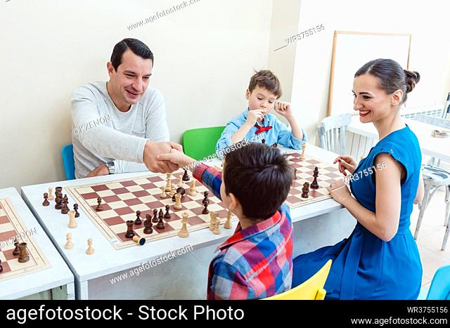 People in chess school learning the game