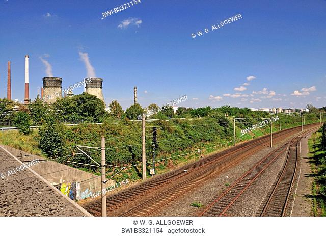 railtracks in front of the vent stacks and burner of an oil refinery, Germany, North Rhine-Westphalia, Godorf bei Wesseling